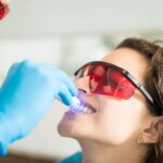 Dentist performing deep cleaning teeth procedure to remove plaque and tartar below the gumline for healthy gums.
