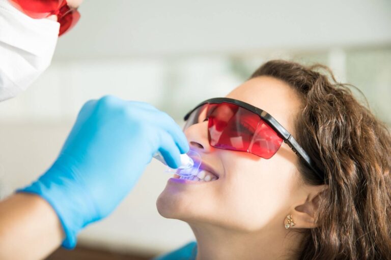 Dentist performing deep cleaning teeth procedure to remove plaque and tartar below the gumline for healthy gums.
