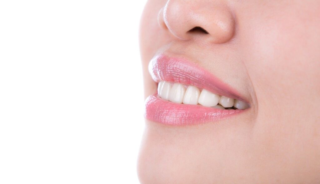 Healthy pink gums and natural white teeth showing normal gum color