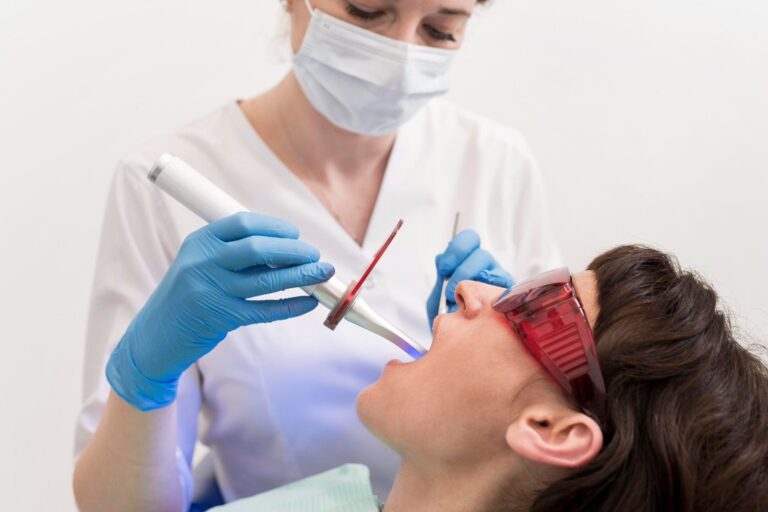 Dentist performing laser gum surgery on a patient