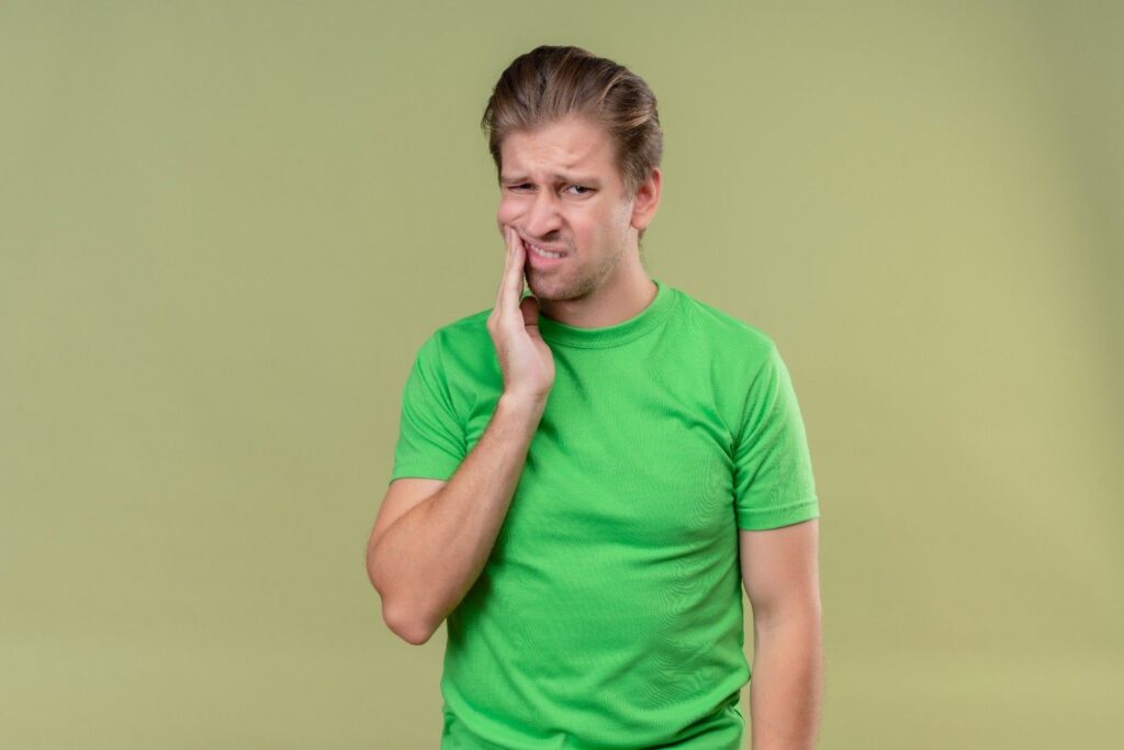Man experiencing gum pain and tooth discomfort