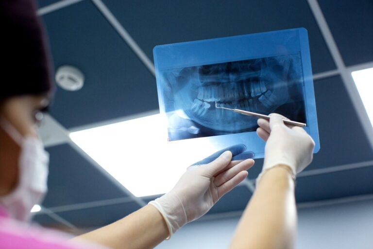 Dentist examining a panoramic dental X-ray